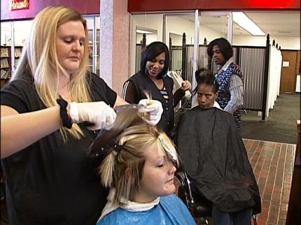 A woman getting her hair cut at the salon